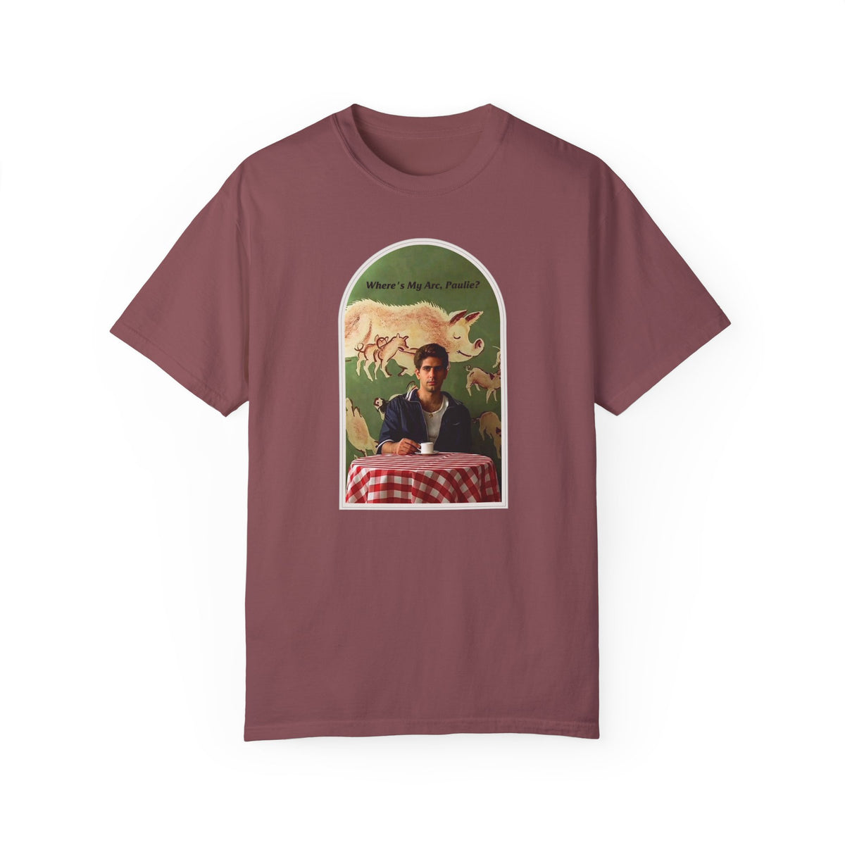 Burgundy T-shirt, front view, with an arched collage of a seated figure and pigs.