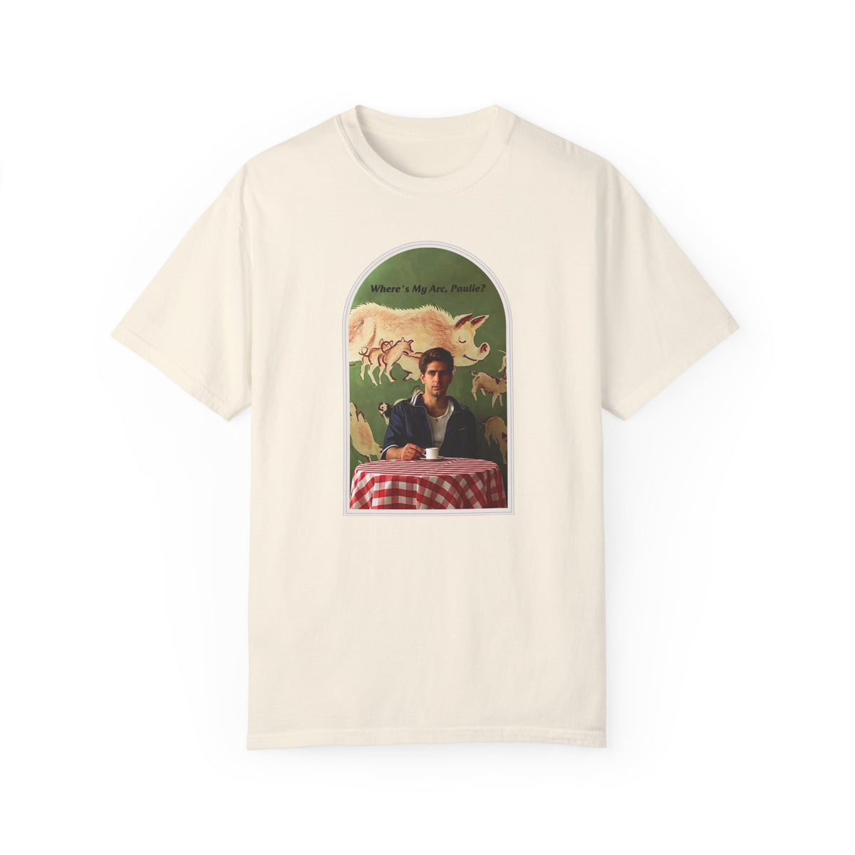Cream T-shirt, front view, with an arched collage of a seated figure and pigs.