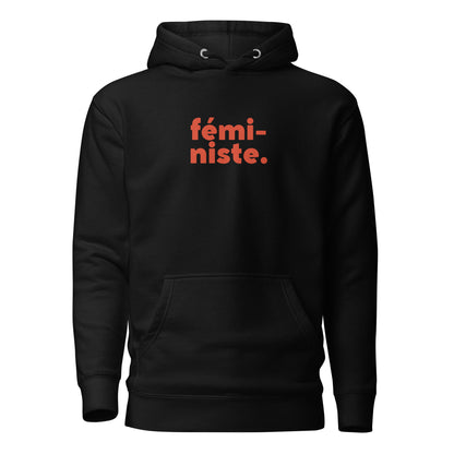 Black hoodie, front view, with red stacked 'fémi-niste.' lettering.
