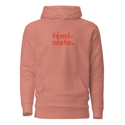 Dusty Rose hoodie, front view, with red stacked 'fémi-niste.' lettering.