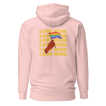 Light Pink hoodie, back view with a hand waving a rainbow flag over yellow "Love Wins" lettering.