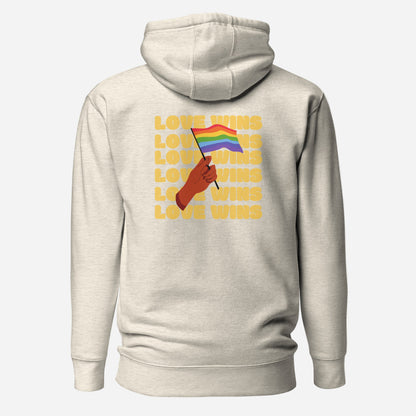Oatmeal Heather hoodie, back view with a hand waving a rainbow flag over yellow "Love Wins" lettering.