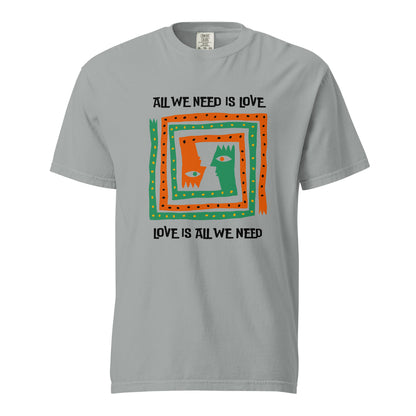 Granite T-shirt, front view, with orange and green abstract faces framed by 'All We Need Is Love' text.