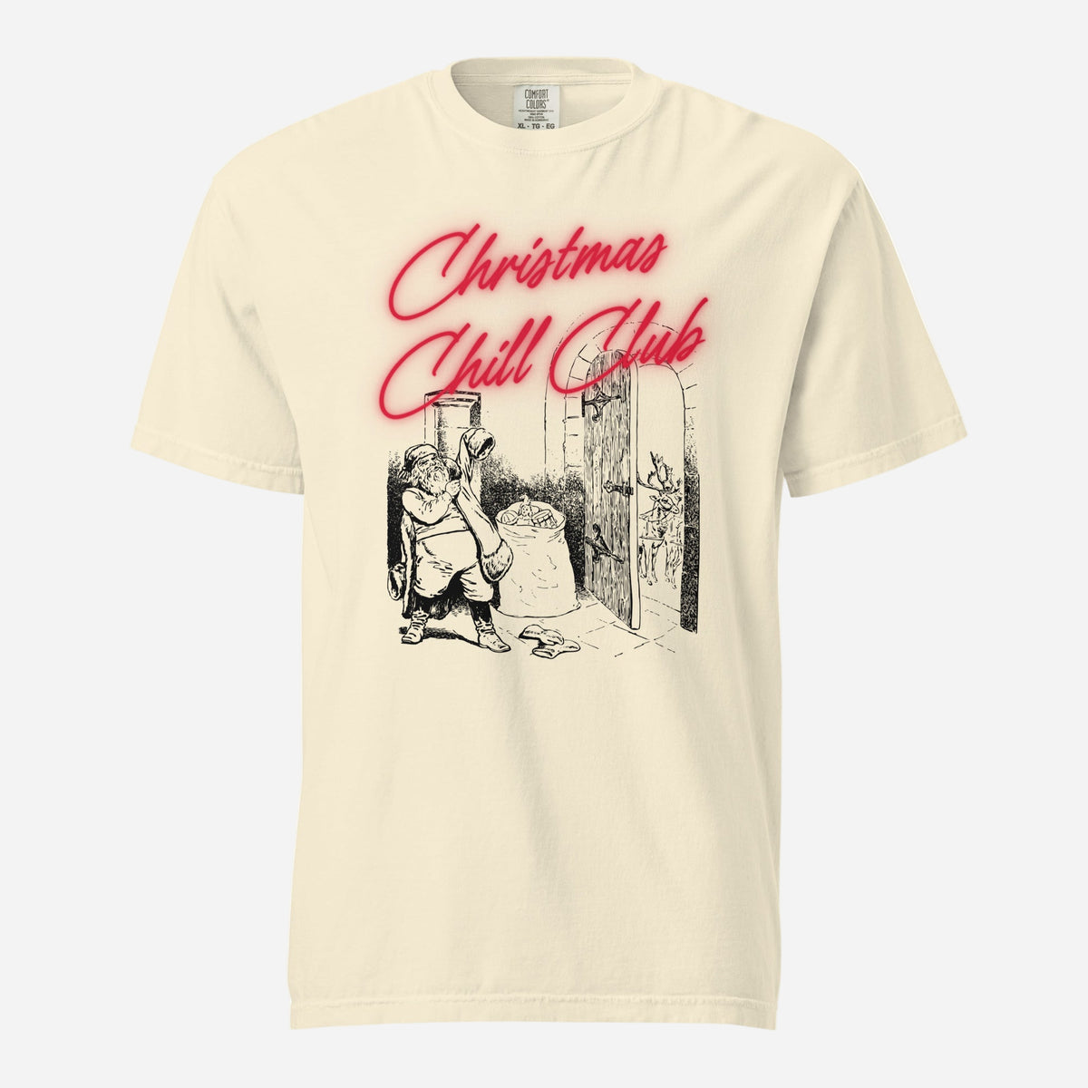 Ivory T-shirt, front view, with a seated Santa illustration beneath red 'Christmas Chill Club' script.