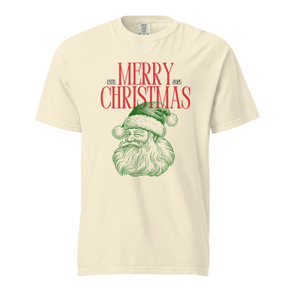 Ivory T-shirt, front view with a green Santa face and red "Merry Christmas" lettering.