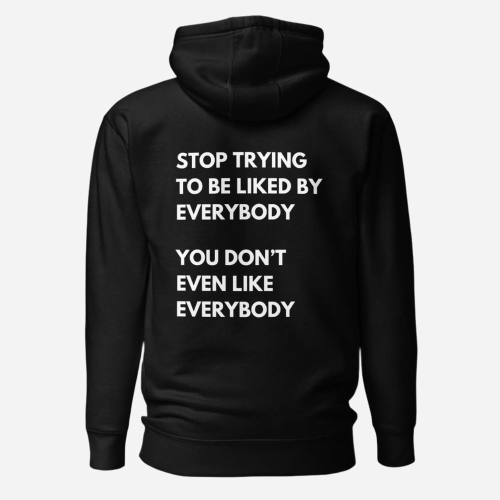 Black hoodie, back view with white stacked "Stop Trying to Be Liked by Everybody" slogan lettering.
