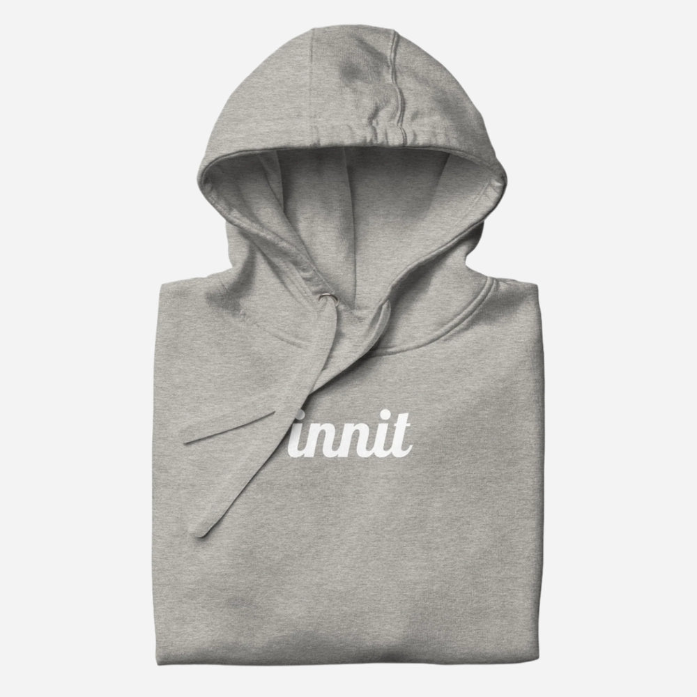 Folded Carbon Grey Innit hoodie showing the hood and white "innit" chest lettering.