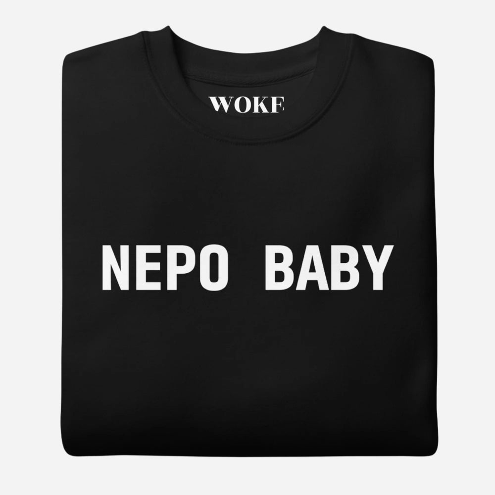 Folded Black sweatshirt, showing white "NEPO BABY" lettering.