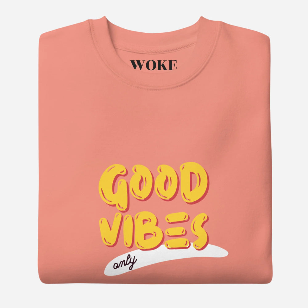 Dusty Rose sweatshirt with yellow Good Vibes Only lettering, folded view.