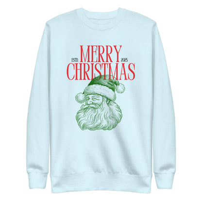Sky Blue sweatshirt, front view, with a green Santa portrait below red 'Merry Christmas' lettering and the year 2025.